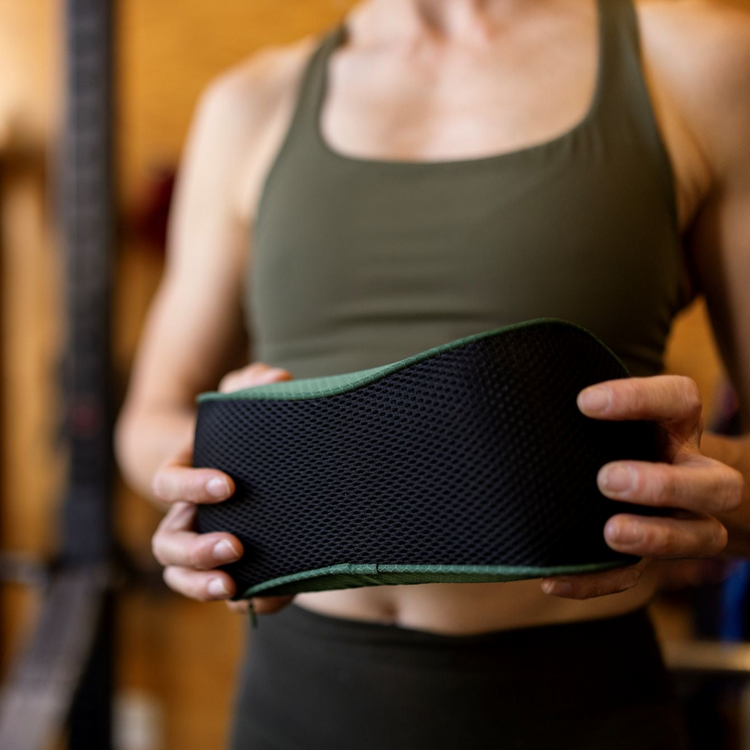 Closeup of a person holding the forteneck neck cushion in front of them