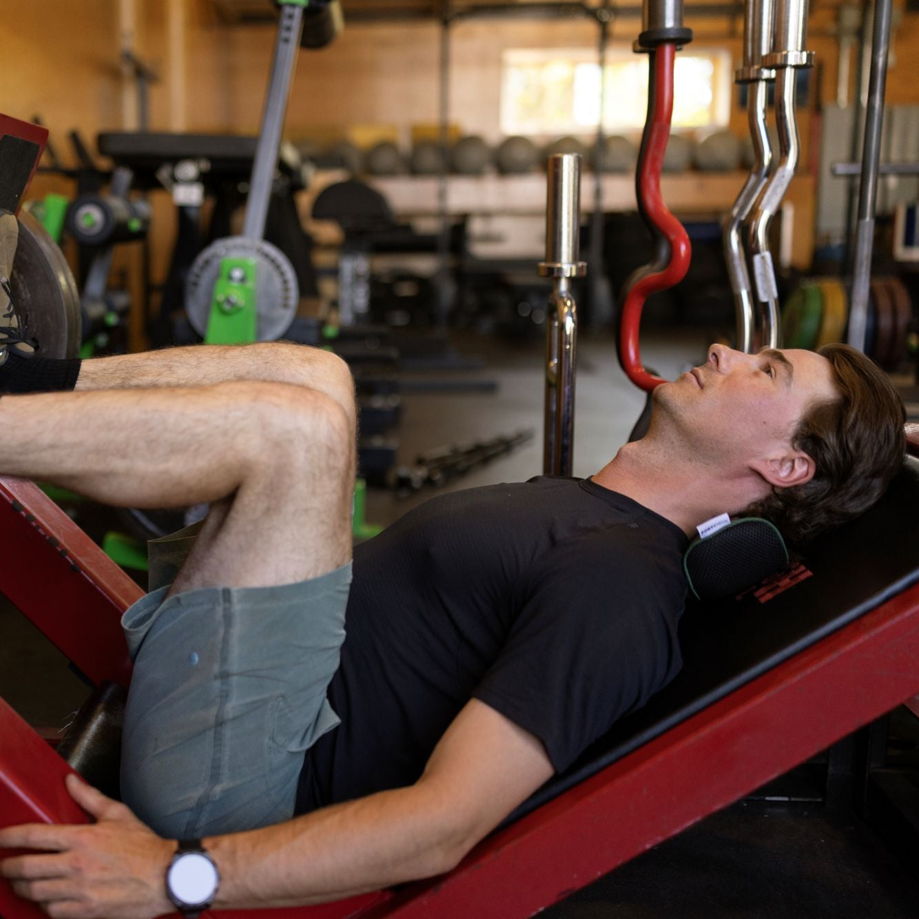 Person using a leg press machine in a gym setting
