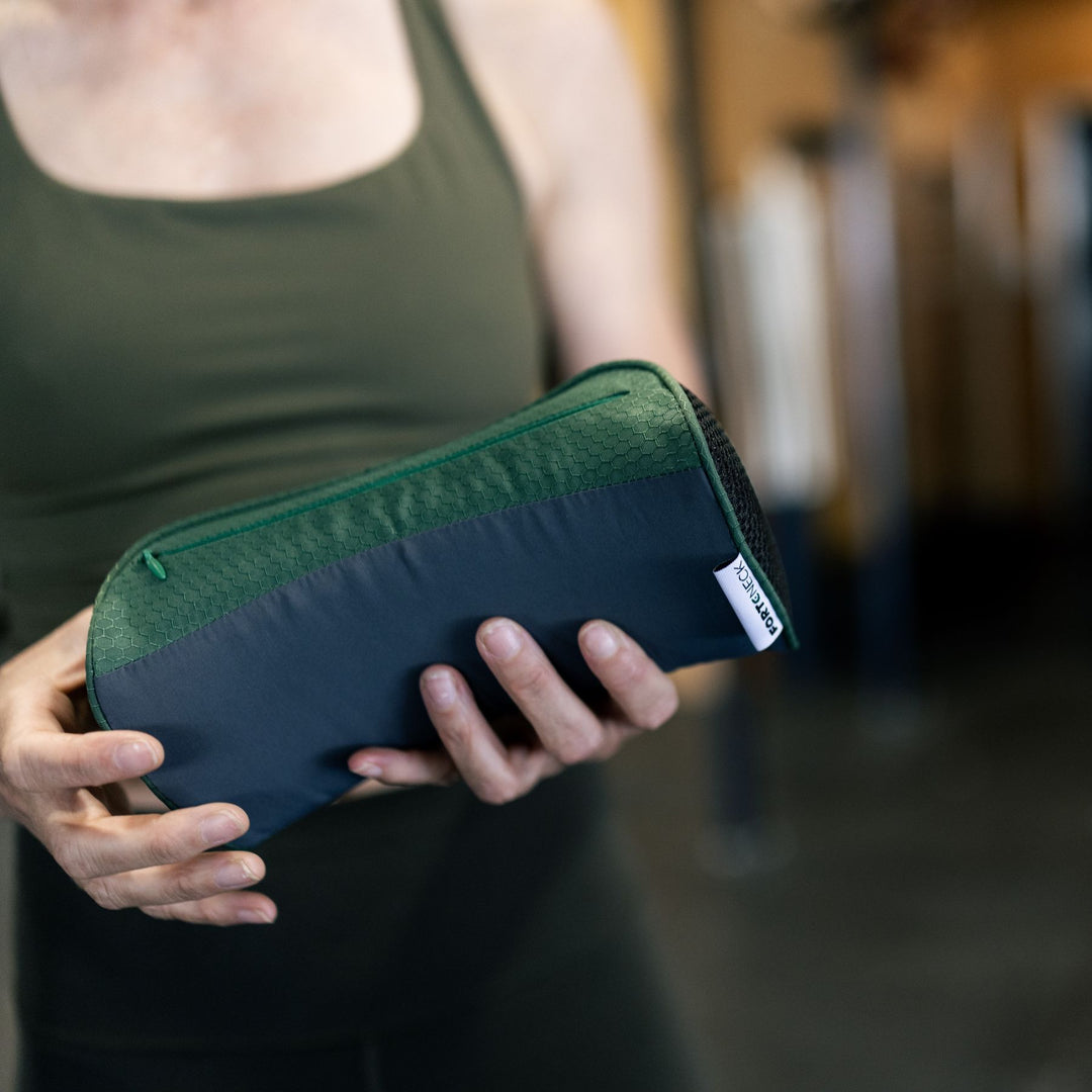 Closeup of a person holding the forteneck neck cushion in front of them